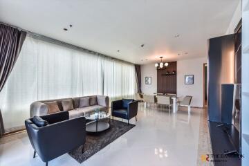 Modern living room with ample natural light and contemporary furnishings