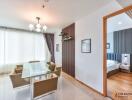 Modern dining area with glass table and six chairs, view into a modern bedroom