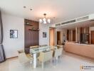 Modern dining area with glass table and kitchen