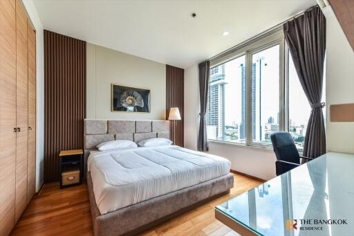 Modern bedroom with large windows and city view