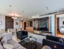 Living room with modern decor, featuring a dining area, a TV, and a glimpse of the bedroom.