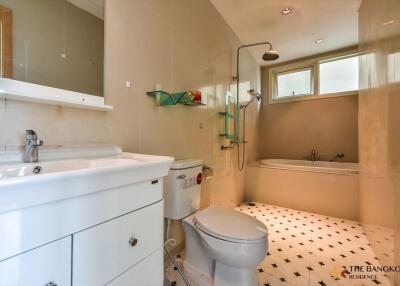 Modern bathroom with white fixtures and tiles