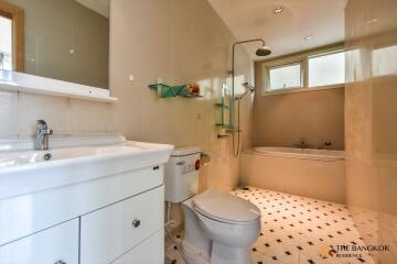 Modern bathroom with white fixtures and tiles