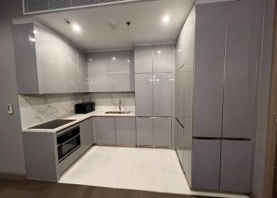 Modern kitchen with sleek gray cabinets and marble backsplash