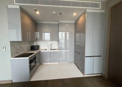 Modern kitchen with grey cabinets and marble backsplash