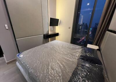 Modern bedroom with city view and protected mattress