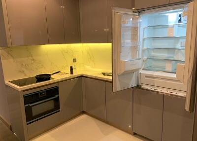 Modern kitchen with appliances and open refrigerator