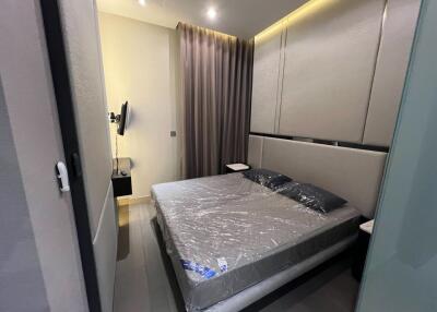 Modern bedroom with a double bed, wall-mounted TV, and ambient lighting