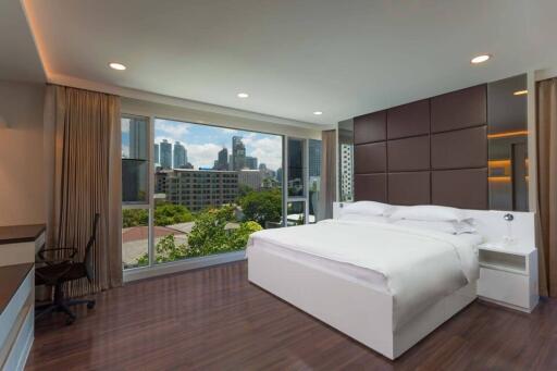 Modern bedroom with large window and city view