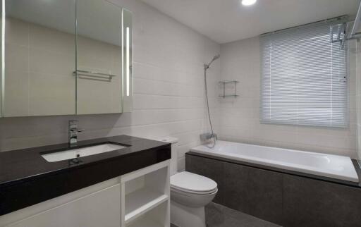 Modern bathroom with sink, toilet, bathtub, and mirror