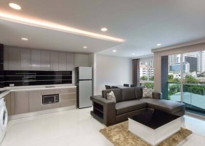 Modern living room with kitchen area and city view