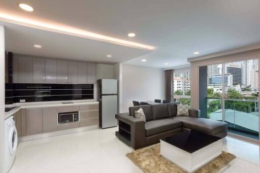 Modern living room with kitchen area and city view