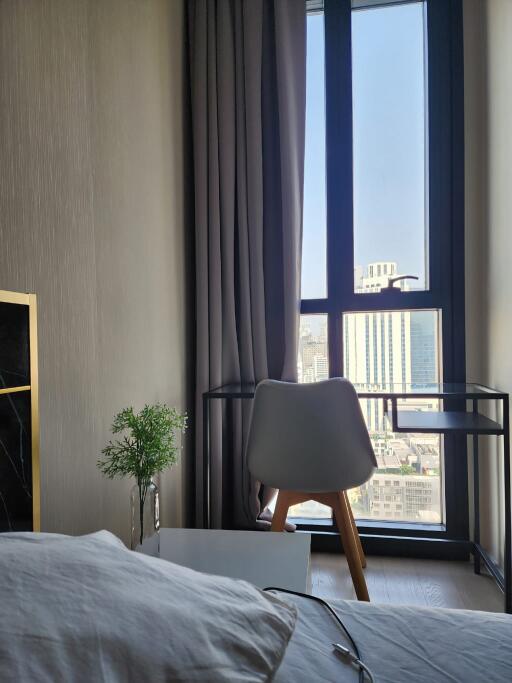 Bedroom with large window and city view