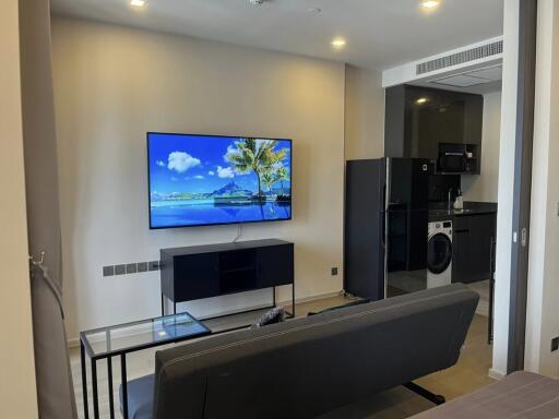 Modern living room with TV and open kitchen