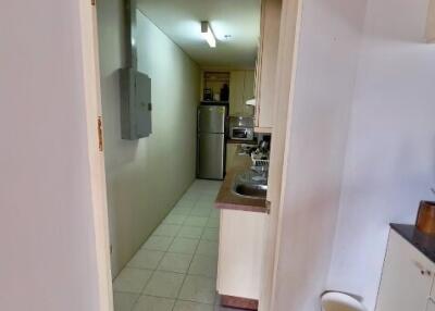 Kitchen area with sink, counter, and fridge