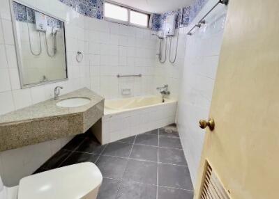 Bathroom with bathtub, vanity, and toilet