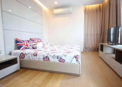 Modern bedroom with minimalist furniture and British-themed bedding