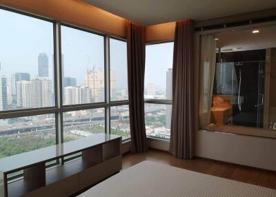 Bedroom with large windows and city view