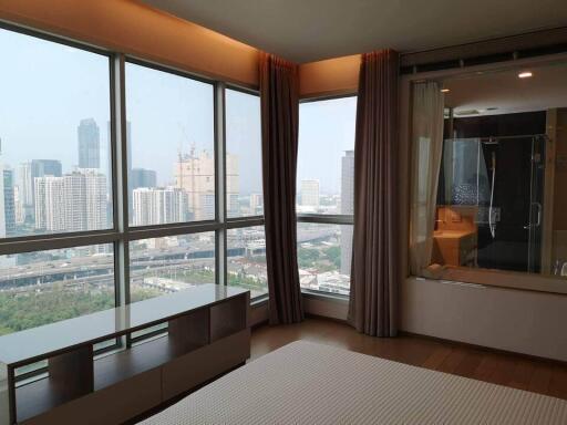 Bedroom with large windows and city view