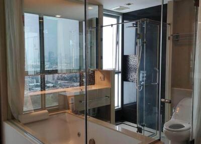 modern bathroom with glass-enclosed tub and shower