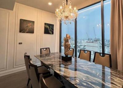 Elegant dining room with a marble table and chandelier