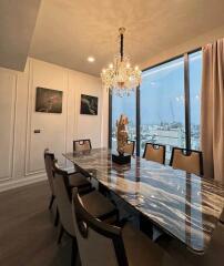 Elegant dining room with a marble table and chandelier