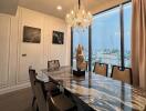 Elegant dining room with a marble table and chandelier