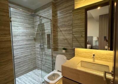 Modern bathroom with glass-enclosed shower and wooden vanity