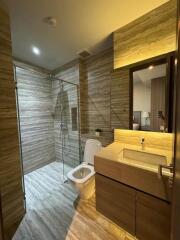 Modern bathroom with glass-enclosed shower and wooden vanity