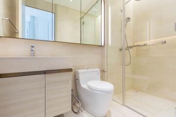 Modern bathroom with vanity, toilet, and glass-enclosed shower