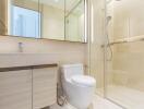 Modern bathroom with vanity, toilet, and glass-enclosed shower