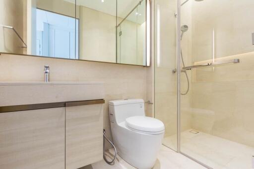 Modern bathroom with vanity, toilet, and glass-enclosed shower