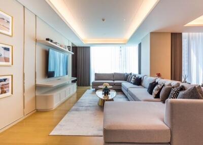 Modern living room with large sectional sofa and wall-mounted TV