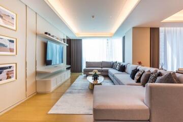 Modern living room with large sectional sofa and wall-mounted TV