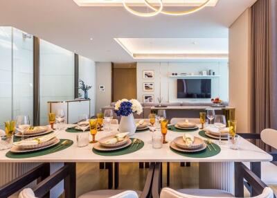 Modern dining room with elegant table setting and view of the living area