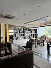 Spacious modern living area with seating and decorative shelving