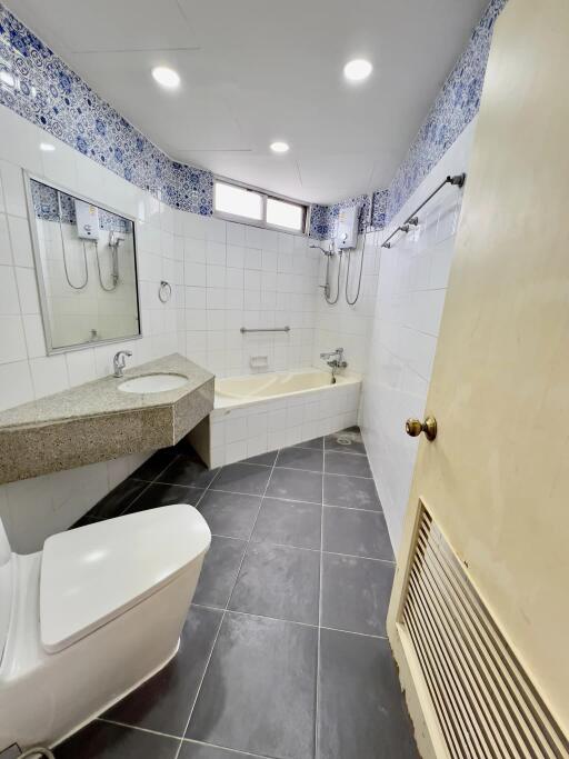 A modern bathroom with tiled walls and flooring