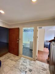 Entryway with access to bathroom and living area