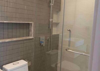 Modern bathroom with glass-enclosed shower and toilet