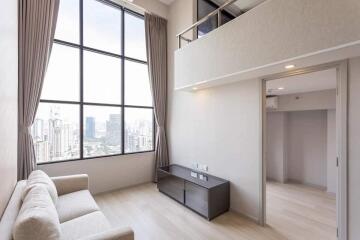 Living room with large window and city view