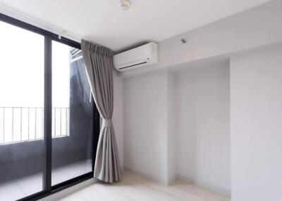 Bright living room with large sliding glass doors and air conditioning unit