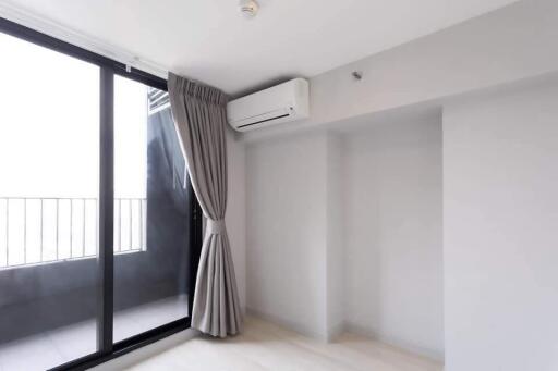 Bright living room with large sliding glass doors and air conditioning unit