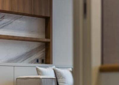 Modern living area with wooden cabinets and marble backsplash