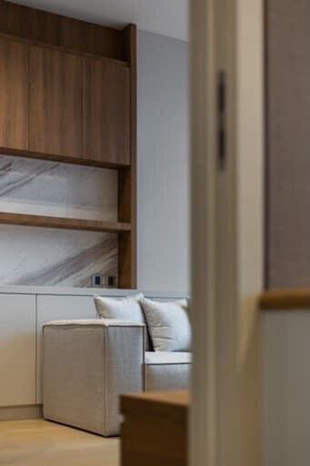 Modern living area with wooden cabinets and marble backsplash