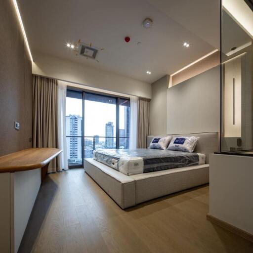 Modern bedroom with large window and city view