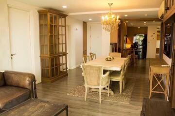 Elegant dining area with wooden furniture and chandelier