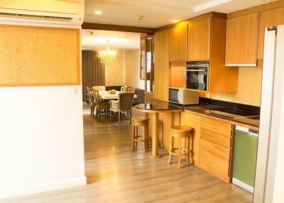 Modern kitchen and dining area with wooden cabinets and dining table