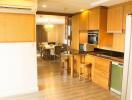 Modern kitchen and dining area with wooden cabinets and dining table