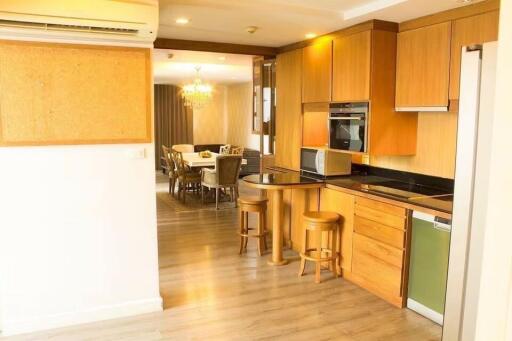 Modern kitchen and dining area with wooden cabinets and dining table