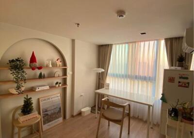 Decorative bedroom with desk, shelves, and window